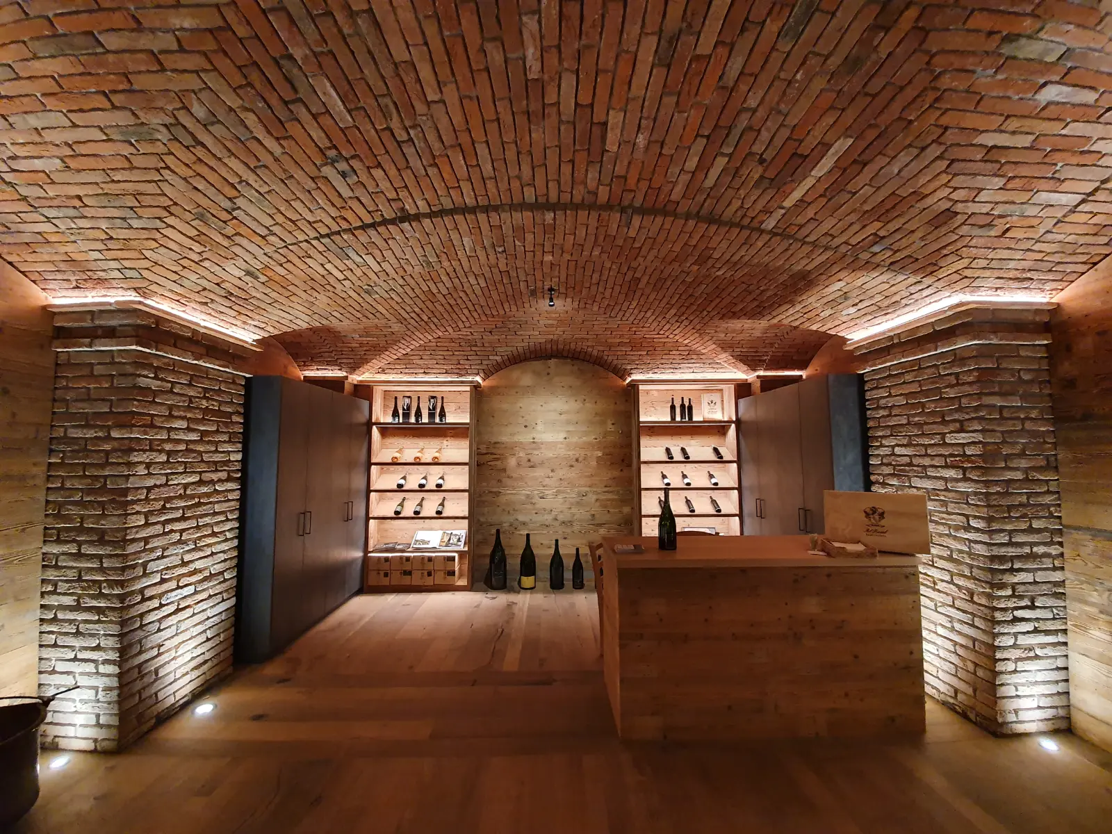 A frontal perspective of a bespoke brick groin vault, meticulously crafted for the tasting sanctuary at Al Rocol winery in Brescia.