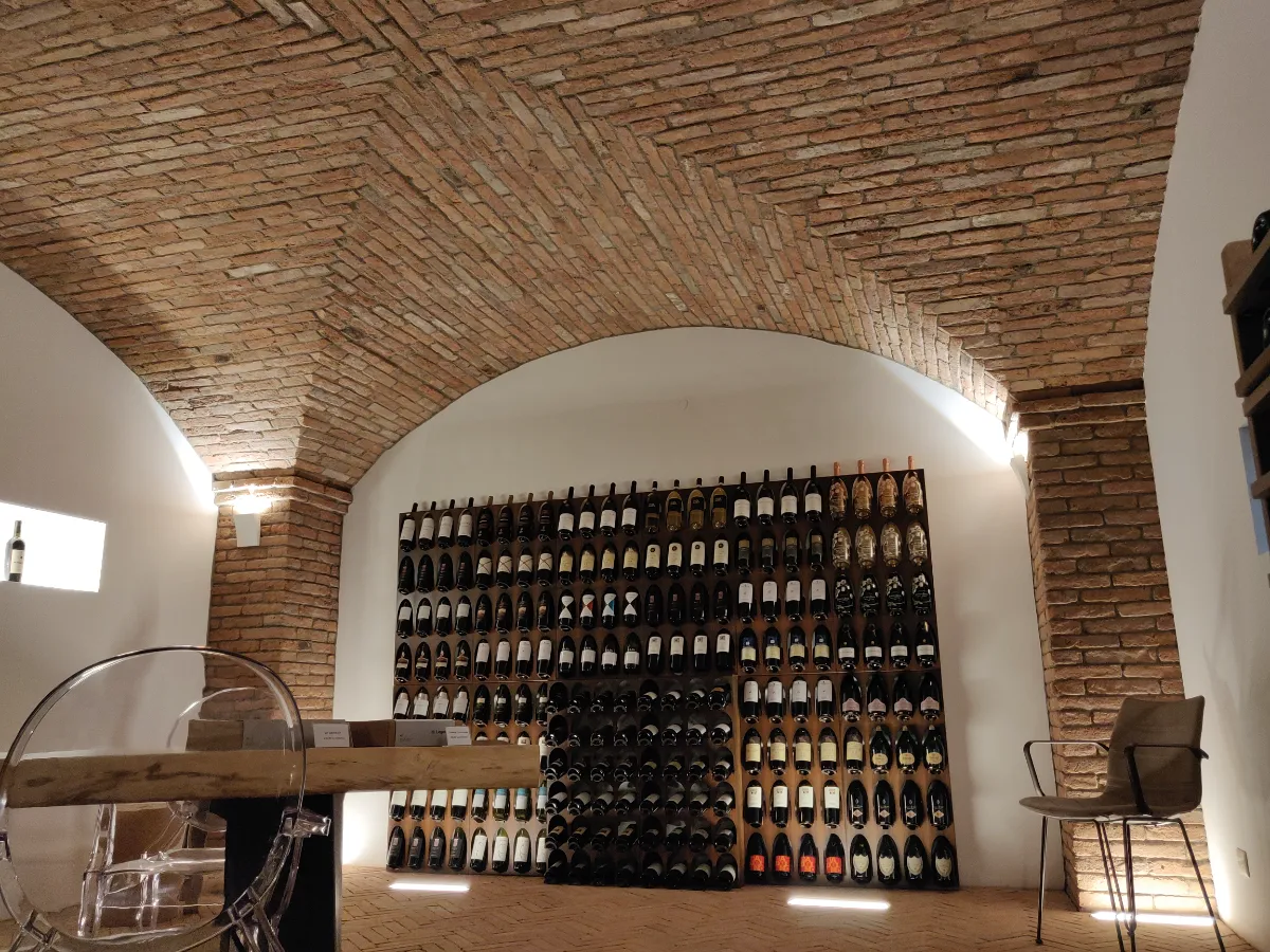 Volta a vela in mattoni sopra una wine room moderna con parete portabottiglie — showcase, studio di design, Milano, realizzata da Pietrantiche