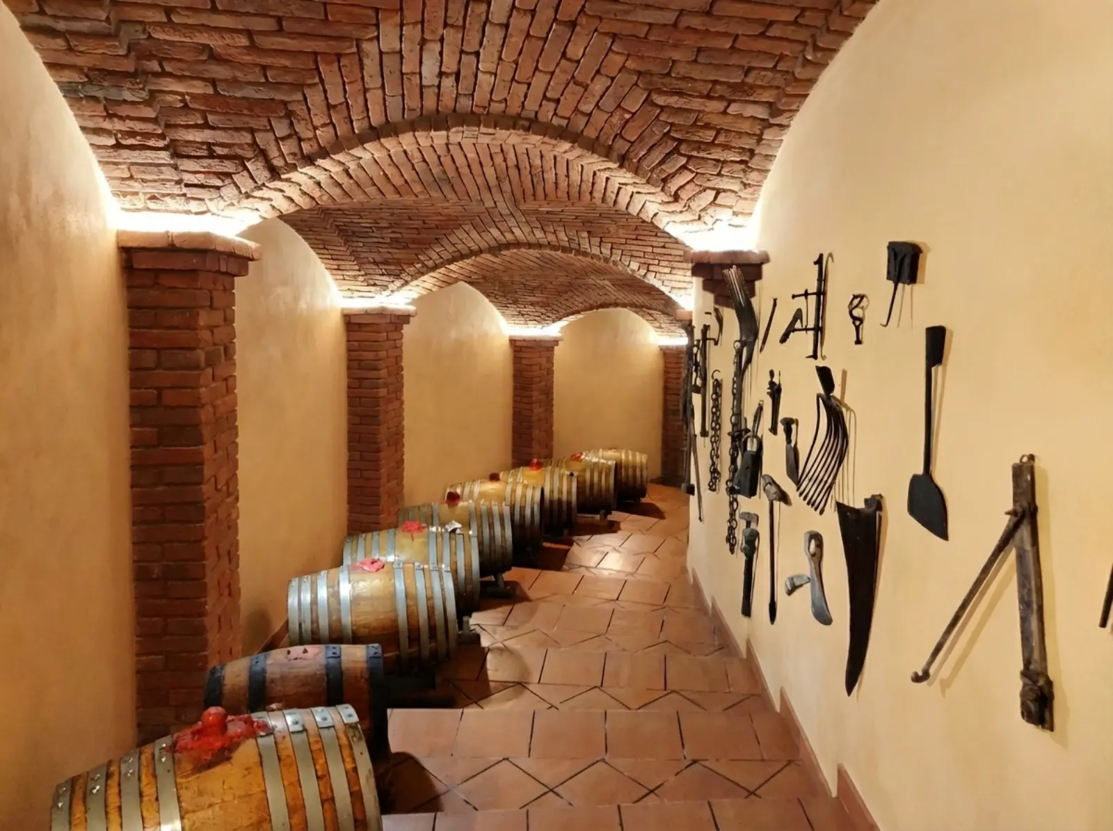 Finished bespoke architectural renovation at Casisano estate in Montalcino. The raw tunnel is transformed into a luxury wine corridor using brick cross vaults with lowered raised arches, creating a warm and evocative tasting experience.